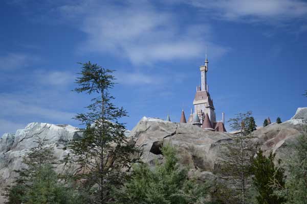 The Beast's castle stands in the background of Fantasyland at Walt Disney World.
