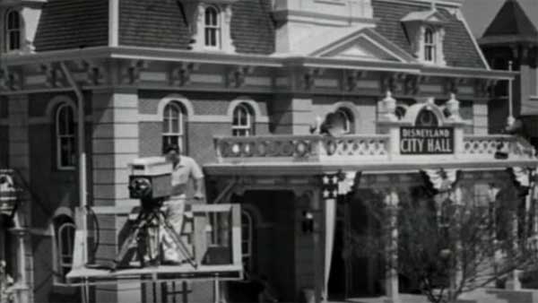 A camera man prepares for a shot near Disneyland's City Hall.