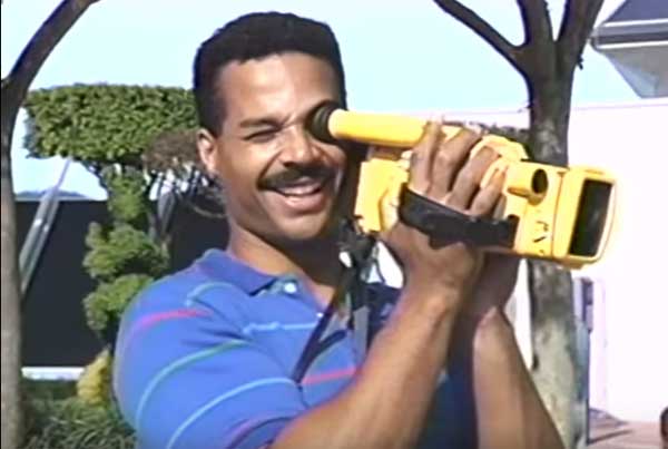 A happy guy uses a high-tech camera in 1991 in A Day at EPCOT Center.