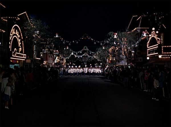 A choir strolls down Main Street in Disneyland during the Christmas celebration.