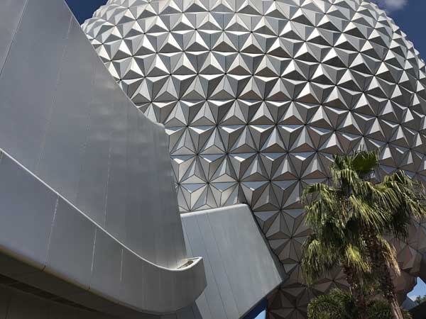 A stunning shot of Spaceship Earth from outside during the day in Epcot.