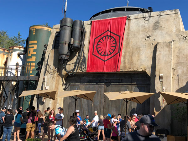 The red banner and First Order logo remind us that the military have a strong presence in Batuu.