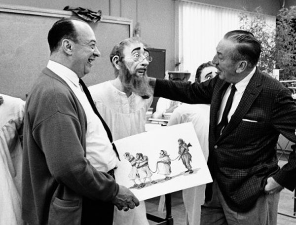 Walt Disney jokes with Imagineer Marc Davis next to an animatronic for the Pirates of the Caribbean at Disneyland.