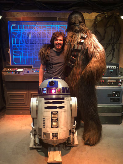 Dustin Engels poses with Chewbacca and R2D2 at the Star Wars Launch Bay.