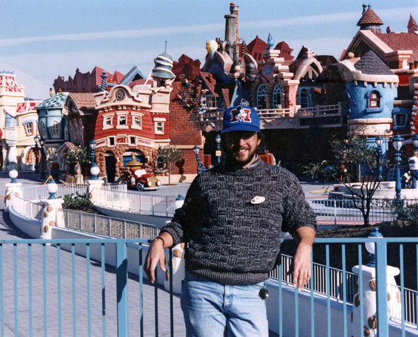 Imagineer Don Carson poses in front of Mickey's Toontown in Disneyland, where he was a show designer.