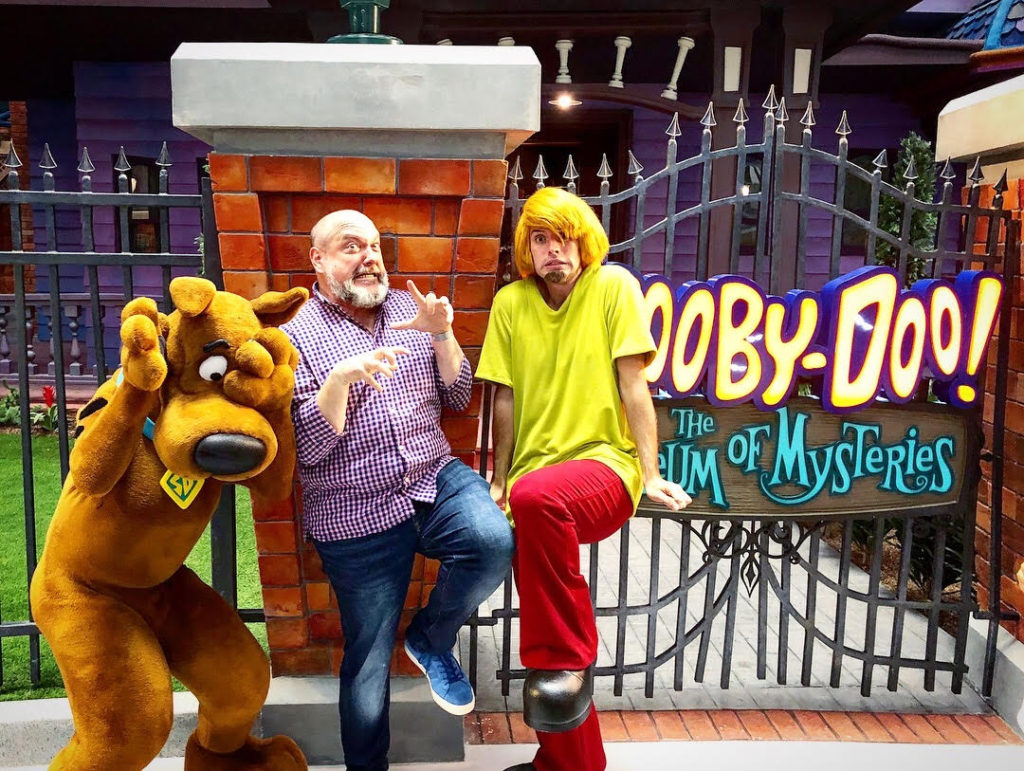 Dave Cobb, park-wide creative director of Warner Bros. World, has fun with Shaggy and Scooby Doo.