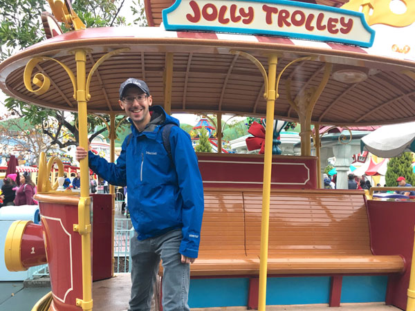 Brett Nachman stands on the Jolly Trolley in Toon Town in Disneyland.