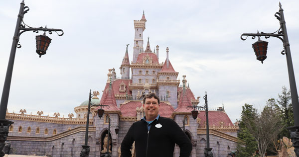 Imagineer Jim Clark stands in front of the Beast's Castle at Tokyo Disneyland.