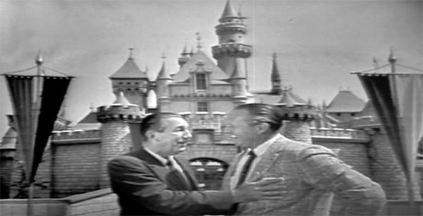 Walt Disney shares a laugh with Art Linkletter in front of Sleeping Beauty Castle.