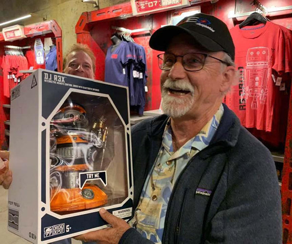 Imagineers Chris Runco and Tom Morris discover the toy of the DJ R3X at Star Wars: Galaxy's Edge.