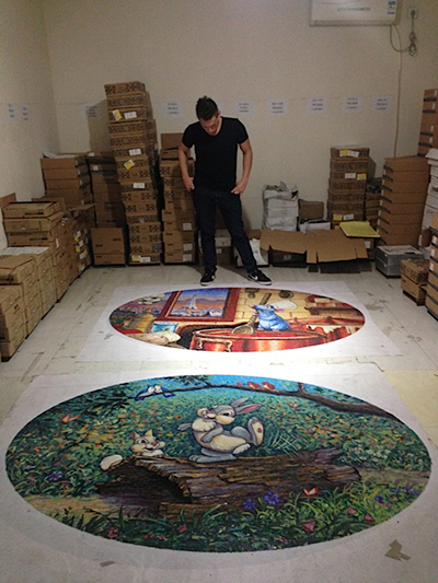 Imagineer Josh Steadman studies the artwork for a project for Disney.