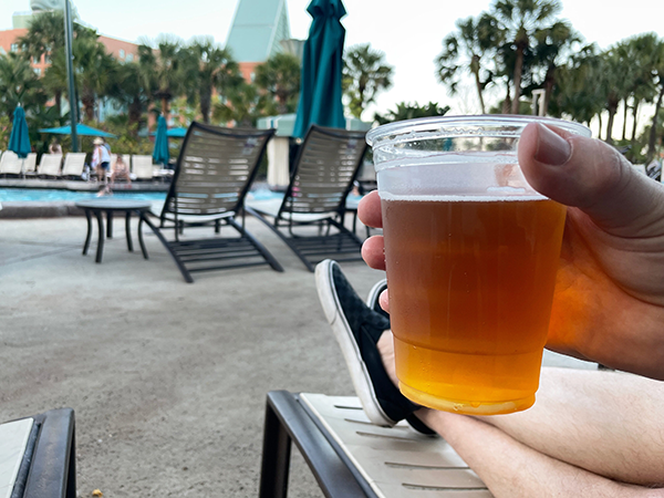 Enjoying a Phins & Feathers pale ale at the Grotto Pool near the Walt Disney World Swan and Dolphin