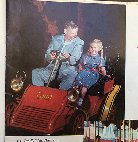 A girl and her dad enjoy Mr. Toad's Wild Ride after leaving hell at Disneyland.