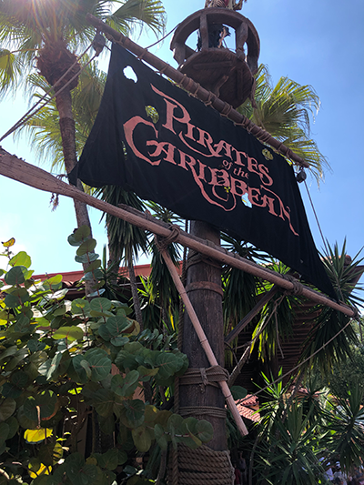 The sign for the classic Pirates of the Caribbean attraction at Walt Disney World.